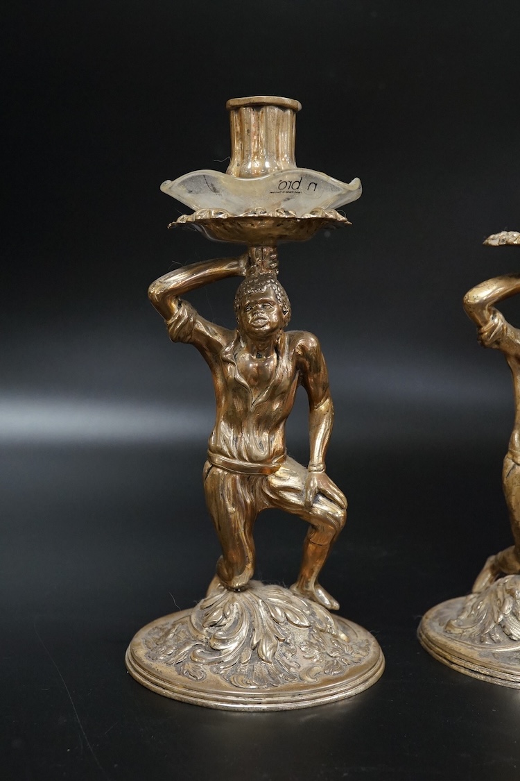 A pair of Blackamoor silvered brass candlesticks, 19cm high